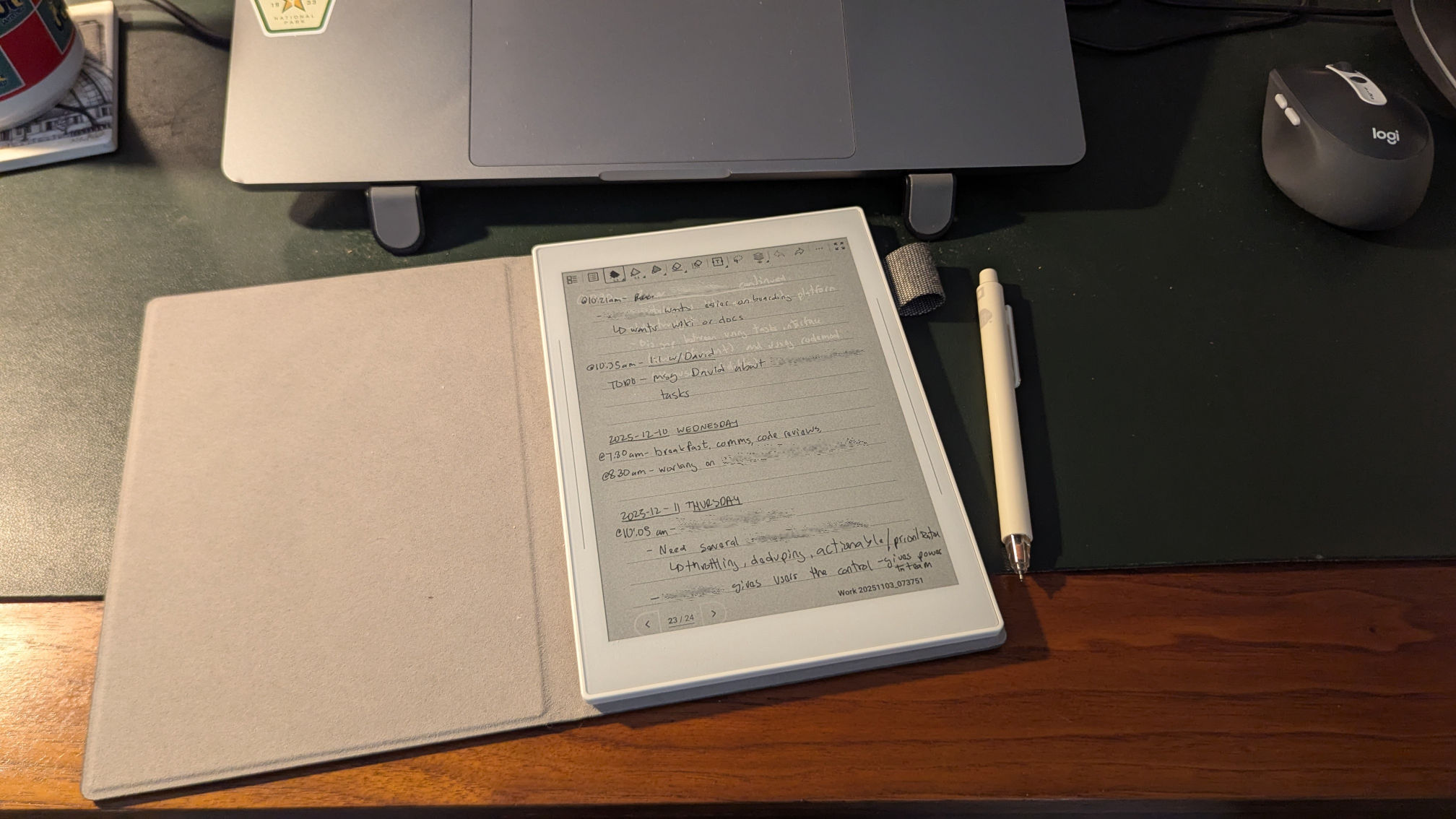 The Supernote Nomad on my desk showing a little bit of the prior page. The text on this page of notes has been anonymized slightly.