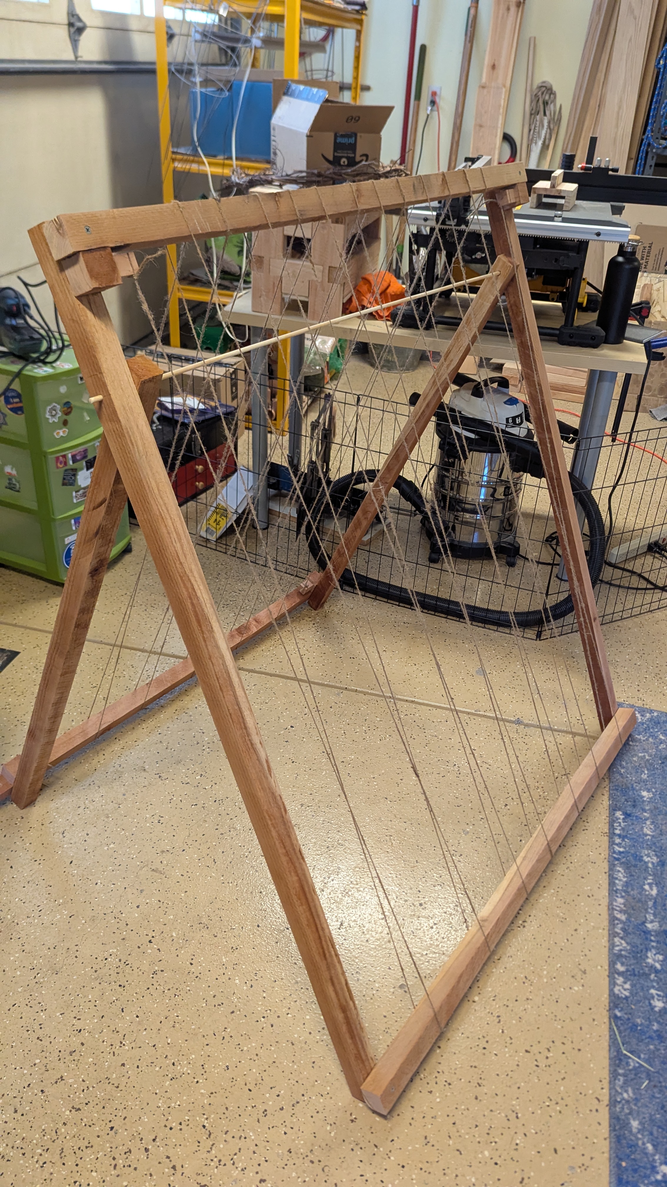 A picture of the collapsible string trellis I built for growing peas and beans.
