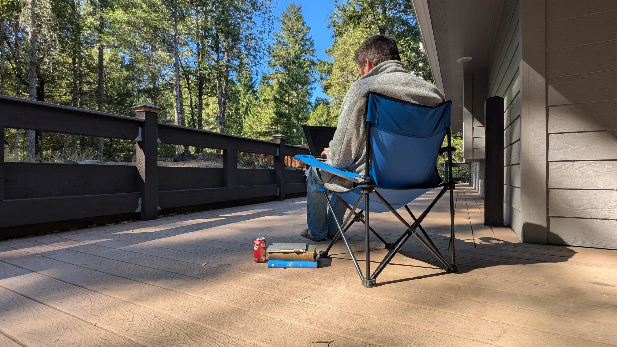 Me sitting in a camp chair on my deck at my cabin in the woods, writing this blog post. Yes, this is a staged photo, but I didn't manipulate it, otherwise I would have edited out my gray hair.